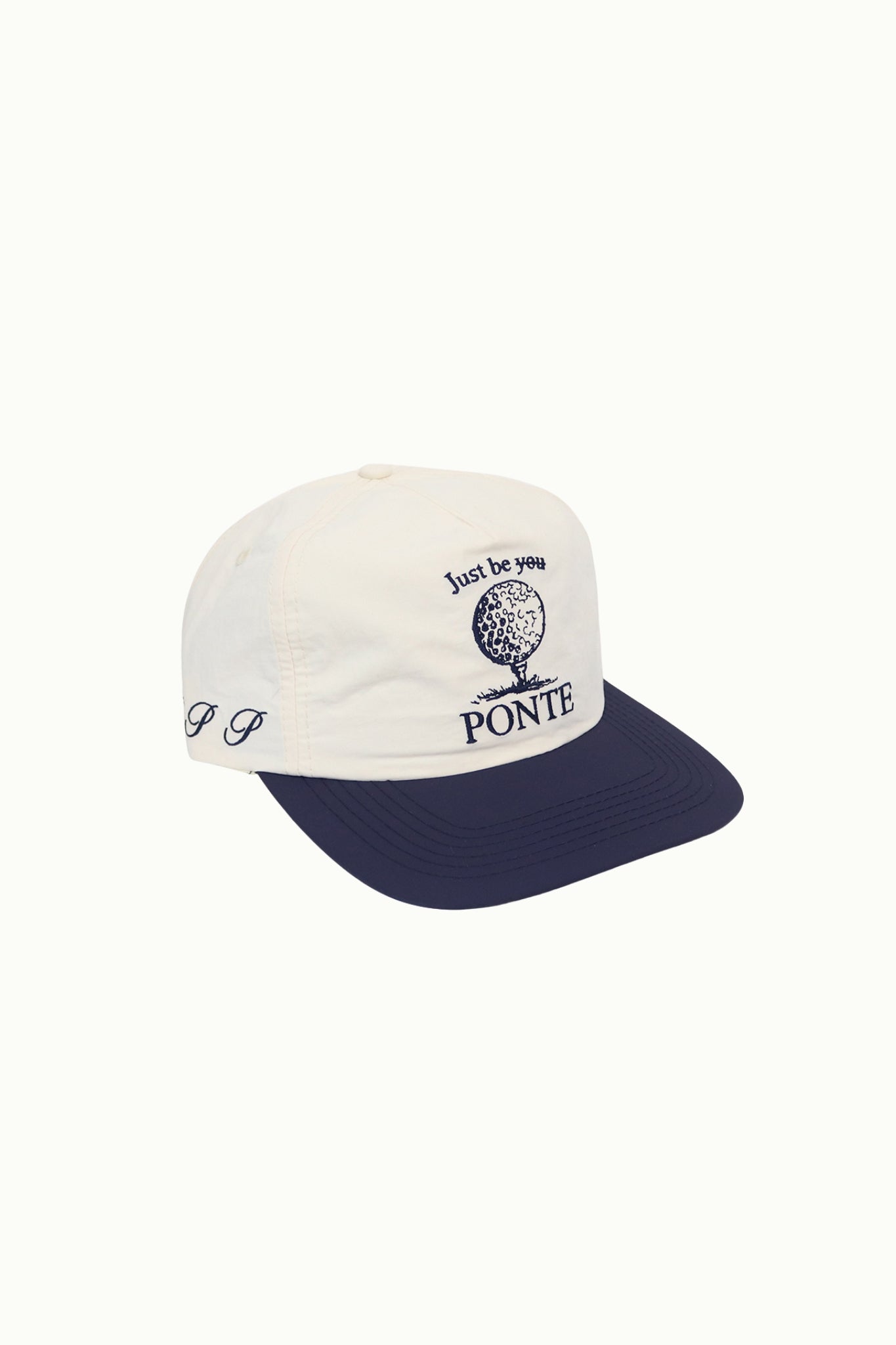 Gorra TEE Point de golf crudo con visera azul marino, gráfico de bola, vista lateral